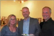  ??  ?? Valerie Campbell of Philadelph­ia, artist Patrick Lee of Pittsburgh and Ken Karlic of Bellair, Md., get together at the CraftForms 2017 opening.