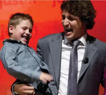  ?? PAUL CHIASSON/THE CANADIAN PRESS ?? MP Justin Trudeau shares a laugh with his son, Xavier, while launching his Liberal leadership bid in Montreal on Tuesday. What the Liberals need is a true leadership contest, not a coronation, writes Tim Harper. But the man who could give Trudeau a run...