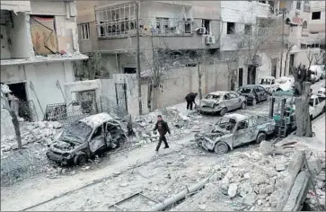  ?? Hamza al Ajweh AFP/Getty Images ?? SYRIAN WARPLANES continued to bomb the rebel-held city of Duma on Sunday despite a cease-fire.