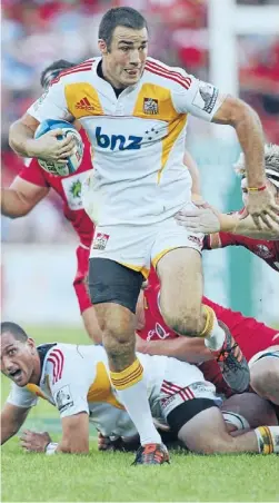  ??  ?? Tough break: Richard Kahui makes a break for the Chiefs before he left the field injured in their match against the Reds in Brisbane last night. Photo: Getty Images