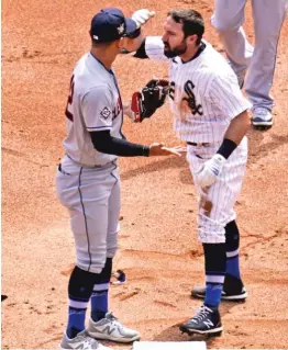  ?? NAM Y. HUH/AP ?? Adam Eaton has a few words with Indians shortstop Andres Gimenez after Gimenez tagged him out at second base in the first inning Thursday.