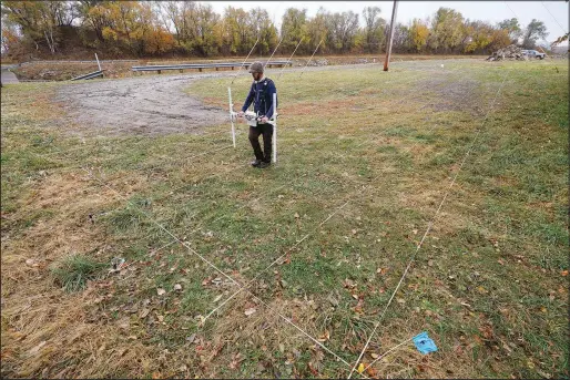  ?? (AP/Charlie Neibergall) ?? A member of a team affiliated with the National Park Service uses ground-penetratin­g radar Oct. 27 in hopes of detecting what is beneath the soil while searching for over 80 Native American children buried at the former Genoa Indian Industrial School in Genoa, Neb.