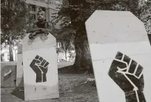  ?? Nathan Howard / Getty Images ?? Paul Clay Jr. of Portland gets ready for Thursday night’s protest in front of the Mark O. Hatfield U.S. Courthouse.