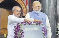  ?? PTI FILE ?? Prime Minister Narendra Modi and then President Pranab Mukherjee at the launch of goods and services tax on July 1.