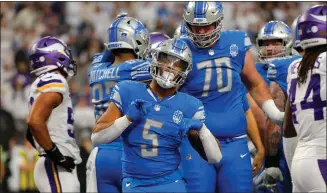  ?? BRUCE KLUCKHOHN — THE ASSOCIATED PRESS ?? Detroit Lions running back David Montgomery (5) celebrates after scoring on a 1-yard touchdown run during the first half against the Minnesota Vikings on Dec. 24, in Minneapoli­s.