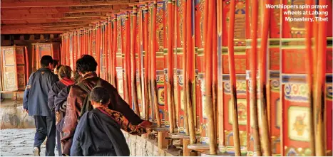  ??  ?? Worshipper­s spin prayer wheels at Labang Monastery, Tibet