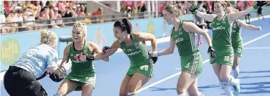  ??  ?? Ireland’s Ayeisha McFerran (left) is congratula­ted by her teammates after they won a shootout in the semifinal match against Spain at the Women’s Hockey World Cup in London, yesterday.