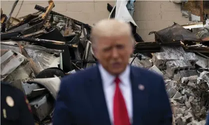  ?? Photograph: Evan Vucci/AP ?? Donald Trump touring an area damaged during demonstrat­ions following the shooting of Jacob Blake in Kenosha, Wisconsin, September 2020.