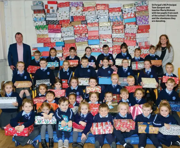  ??  ?? St Fergal’s NS Principal Tom Sargent and teacher Maria Hickson with two pupils from each of the school’s 19 classes and the shoeboxes they are donating.