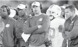  ?? GAIL BURTON/AP ?? Head coach Adam Gase, center, says he is done compromisi­ng with anyone and those that don’t want to get on board will be gone.