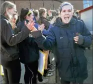  ?? CATHERINE AVALONE — NEW HAVEN REGISTER ?? Quinnipiac guard Carly Fabbri walks through giving high fives to fans as the women’s basketball team attends a Sweet 16 Send-Off Rally at the TD Bank Sports Center.