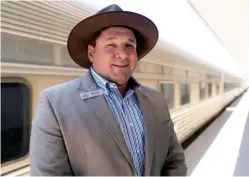  ??  ?? Train manager Dean Duka is at the ready to greet his guests as they arrive to board the Indian Pacific at East Perth Station, for their journey across the continent.