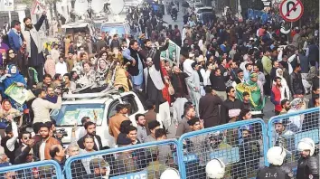  ?? AFP ?? A security convoy transporti­ng arrested opposition leader Shahbaz Sharif enters the corruption court for a case hearing in Lahore yesterday.