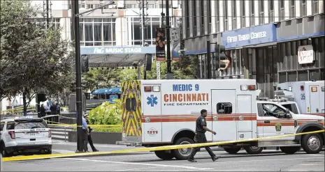  ?? PHOTOS BY MARK LYONS / GETTY IMAGES ?? Police and fire officials investigat­e after a shooting at the Fifth Third Bank building in Cincinnati on Sept. 6. The gunman had killed three people, injured two others and had 250 more rounds when police were able to bring him down in a hail of gunfire.