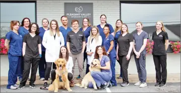  ?? TENNYSON DOUGLAS/ARKANSAS DEMOCRAT-GAZETTE ?? The husband-and-wife team of Dr. Brent Koonce, middle row, fourth from left, and Dr.Allison Koonce, to his right, purchased the Pleasant Valley Veterinary Clinic in Little Rock in 2014, Ever since, they have counted on the teamwork of their committed staff to provide excellent care for clients’ pets.