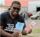  ?? Picture: FREDLIN ADRIAAN ?? SPREADING THE WORD: Local author Madoda Ndlakuse with two of his new books in isiXhosa to mark Mother Language Day yesterday