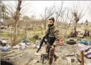  ?? AP ?? A Us-backed Syrian Democratic Forces fighter walks inside a tent encampment that was occupied by IS militants in Baghouz.