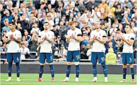  ??  ?? Tribute: Tottenham players and supporters observe a minute’s applause for Jimmy Greaves prior to their clash with Chelsea