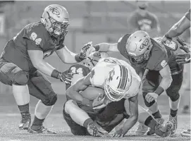  ?? Joe Buvid ?? Atascocita quarterbac­k Darius Edmonds (15), who was harassed all game by the Klein Collins defense, is sacked by Josh Allison in the first half Thursday night.