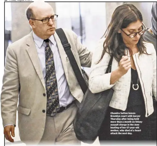  ??  ?? Chandra Sutton leaves Brooklyn court with lawyer Thursday after being held more than a month on felony assault charge in the June beating of her 67-year-old mother, who died of a heart attack the next day.