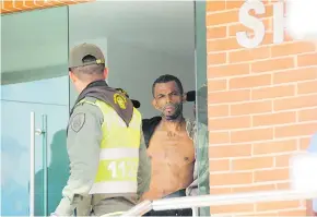  ?? JHONY OLIVARES ?? El cantante cuando salía del edificio acompañado por agentes de la Policía.