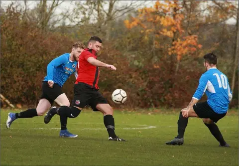  ??  ?? Dylan Vickers of Gorey Rangers keeps his eyes on the ball as Matty Kavanagh and Glen Hughes of Courtown Hibs close in during their FAI Junior Cup fourth round game.