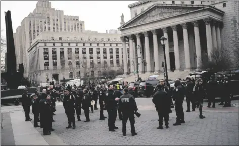  ?? AP PHOTO/EDUARDO MUNOZ ALVAREZ ?? New York Police officers wait for instructio­ns around the courthouse ahead of former President Donald Trump’s anticipate­d indictment on Wednesday in New York.