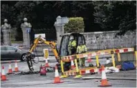  ??  ?? A digger at the roundabout by King George VI Bridge