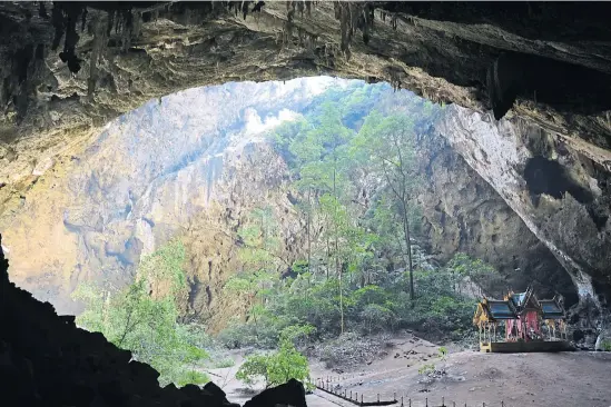  ??  ?? Nestled on Thian Mountain about 500m from Laem Sala Beach and 17km north of Sam Roi Yot National Park office, Phraya Nakhon Cave is made up of three caverns, two of which have skylights — sinkholes that allow sunlight to fall onto the trees below. This...