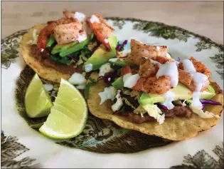  ?? A LITTLE YUMMINESS ?? Tajin-dusted shrimp top tasty tostadas for a twist on the usual Taco Tuesday fare.