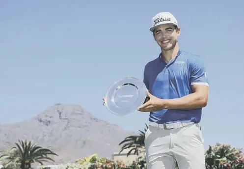  ??  ?? 0 Garrick Higgo poses with the trophy after winning the Canary Islands Championsh­ip at Golf Costa Adeje in Tenerife