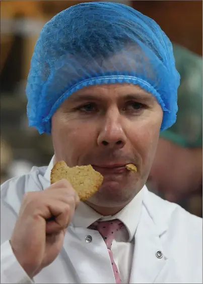  ?? Picture: Gordon Terris ?? „ Oh crumbs... Derek Mackay tastes the product on a visit to the Nairn’s oatcakes factory in Edinburgh yesterday.