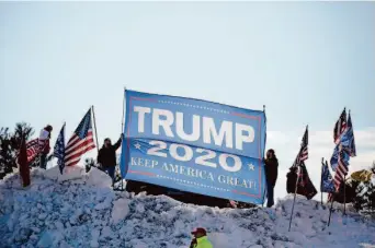  ?? Reba Saldanha/Associated Press ?? Backers of former President Donald Trump show their support for the Republican candidate before his appearance at the New Hampshire GOP’s annual meeting in the town of Salem.