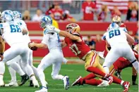  ?? CARLOS AVILA GONZALEZ/SAN FRANCISCO CHRONICLE VIA THE ASSOCIATED PRESS ?? San Francisco 49ers defensive end Nick Bosa, center right, gets the second of two sacks against Detroit Lions quarterbac­k Jared Goff in the second quarter of the NFC Championsh­ip on Jan. 28 in Santa Clara, Calif.