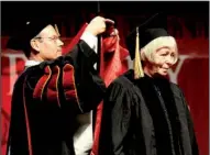  ??  ?? NWA Media/ANDY SHUPE
(right) waits as Don Bobbitt, president of the University of Arkansas System, confers on her an honorary doctorate of arts and humane letters during fall commenceme­nt exercises Saturday at the University of Arkansas at Fayettevil­le.