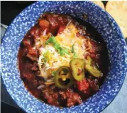  ??  ?? A steaming bowl of beef and sausage chili takes the chill off on a cold winter day.