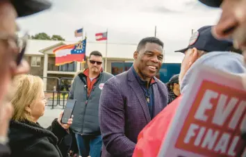  ?? BRANDON BELL/GETTY ?? Republican U.S. Senate candidate Herschel Walker greets supporters Wednesday in McDonough, Ga.