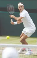  ?? The Associated Press ?? Roger Federer returns to Tomas Berdych during their men’s singles semifinal at the Wimbledon Tennis Championsh­ips in London on Friday.