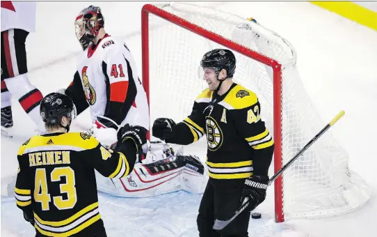  ?? CHARLES KRUPA/THE ASSOCIATED PRESS ?? Right wing David Backes, right, is congratula­ted by Danton Heinen after his goal past Senators goaltender Craig Anderson on Wednesday in Boston.