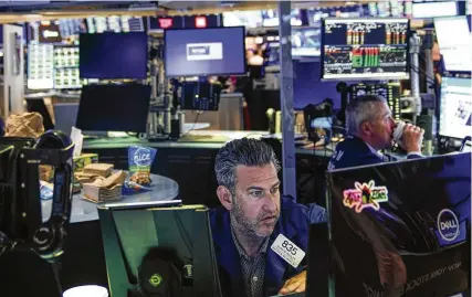  ?? SETH WENIG / AP ?? Traders work on the floor at the New York Stock Exchange in New York on July 26. Inflation and stock market volatility are dragging down the confidence of many American workers dreaming of retirement.