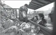  ?? MIAO JIAN / FOR CHIAN DAILY ?? Residents buy cabbages in Wuhan, Hubei province, on Tuesday, as some worry supplies of cheap, fresh vegetables could run low in the coming days. Weather forecasts suggest the city will experience several days of rain and snow.