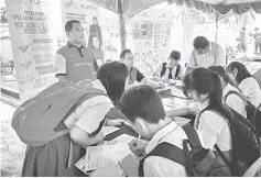  ??  ?? Students fill up forms for further studies after the SPM.