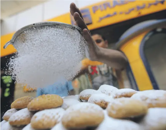  ?? Reuters ?? An Egyptian worker makes ‘Kahk’ traditiona­l sweets at a bakery in Cairo for Eid Al Fitr celebratio­ns. Most Egyptians have a sweet tooth