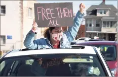  ?? Ned Gerard / Hearst Connecticu­t Media file pyhoto ?? A woman gestures through the sunroof of a car during a protest outside the Bridgeport Correction­al Center on April 15, 2020.