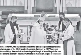  ?? SCREENSHOT/IFI ?? Rhee Timbang, the supreme bishop of the iglesia Filipina independie­nte, gives a copy of the ifi’s liturgical book and directory to CBCP Secretary general msgr. bernardo Pantin during the liturgical launching of the two
documents at the ifi national Cathedral in manila on august 3.