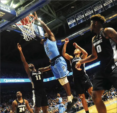  ?? Photos by Ernest A. Brown ?? Cyril Langevine (10) and Rhode Island snapped a seven-game losing streak to in-state rival Providence Saturday night at the Ryan Center. The Rams forced Kyron Cartwright (24) and the Friars to commit 21 turnovers in a 75-68 victory.