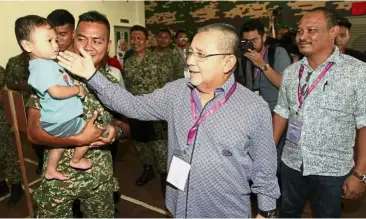  ??  ?? Meeting the future: Isa campaignin­g during early voting at the Army Basic Training Centre at Segenting Camp, Port Dickson.