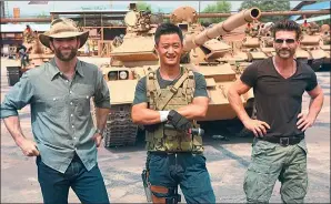  ?? PROVIDED TO CHINA DAILY ?? Wu Jing (center), director and leading actor of Wolf Warrior II, with Italian-American co-star Frank Grillo (right) and American stunt master Sam Hargrave at a filming site.