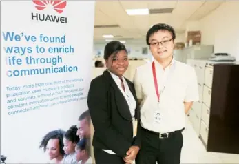  ?? LOUISE BURKE / FOR CHINA DAILY ?? Geoffrey Li (right), public relations manager for Huawei Technologi­es Ghana, and Ruby Boateng, a compensati­on and benefits specialist, at Huawei’s Ghana company.