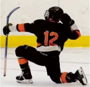  ?? JONATHAN WIGGS/GLOBE STAFF ?? Woburn junior forward Jack Lee goes into celebratio­n mode after potting a late third-period goal for his hat trick.